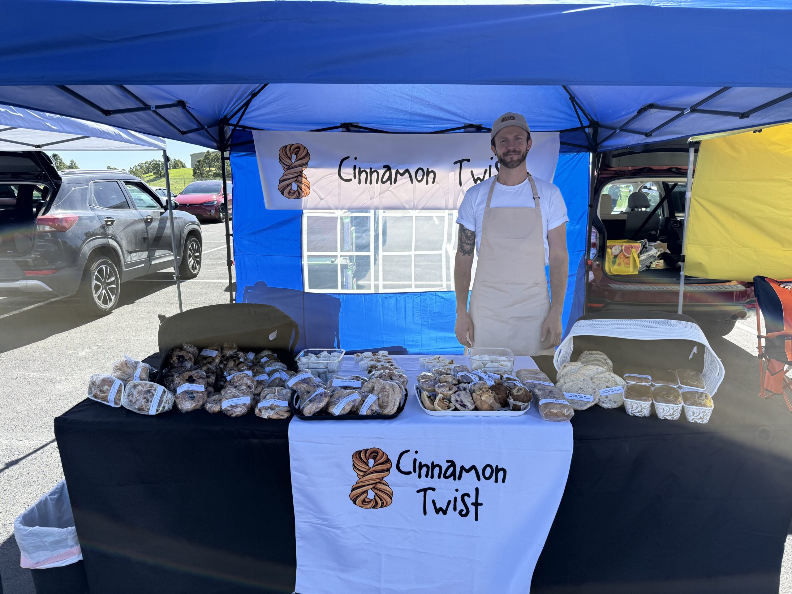The Cinnamon Twist team at a Colorado farmers market booth